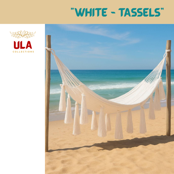 White Hammock with Large Tassels on a beach. Luxurious, hand-woven hammock in bright white for a boho, tropical look. Perfect for beach, garden, or patio lounging.