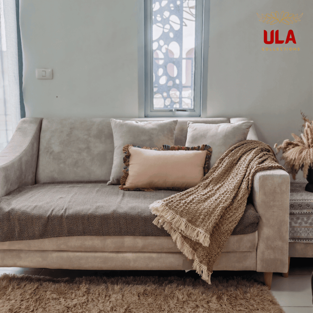 Cozy almond textured throw blanket draped over a beige sofa in a modern living room