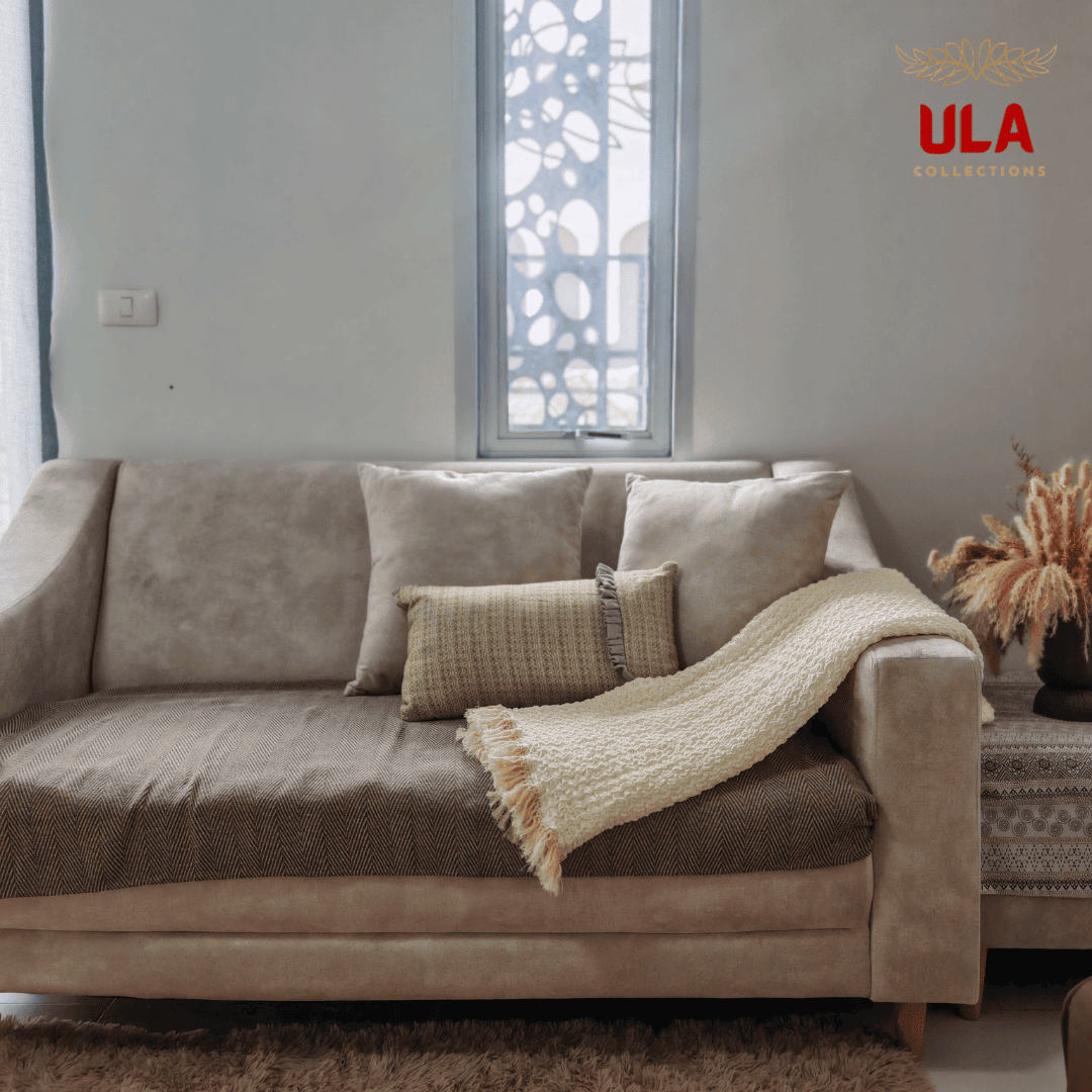 Cozy buttercream blanket with ruffle texture folded diagonally on a modern sofa